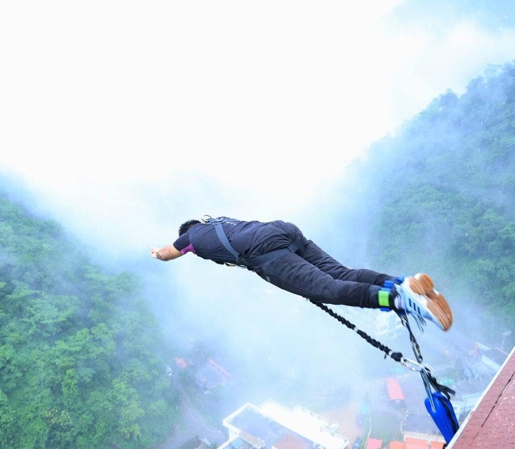 A bungee jumper in free-fall off the 117 m platform near Laxman Jhula, Rishikesh