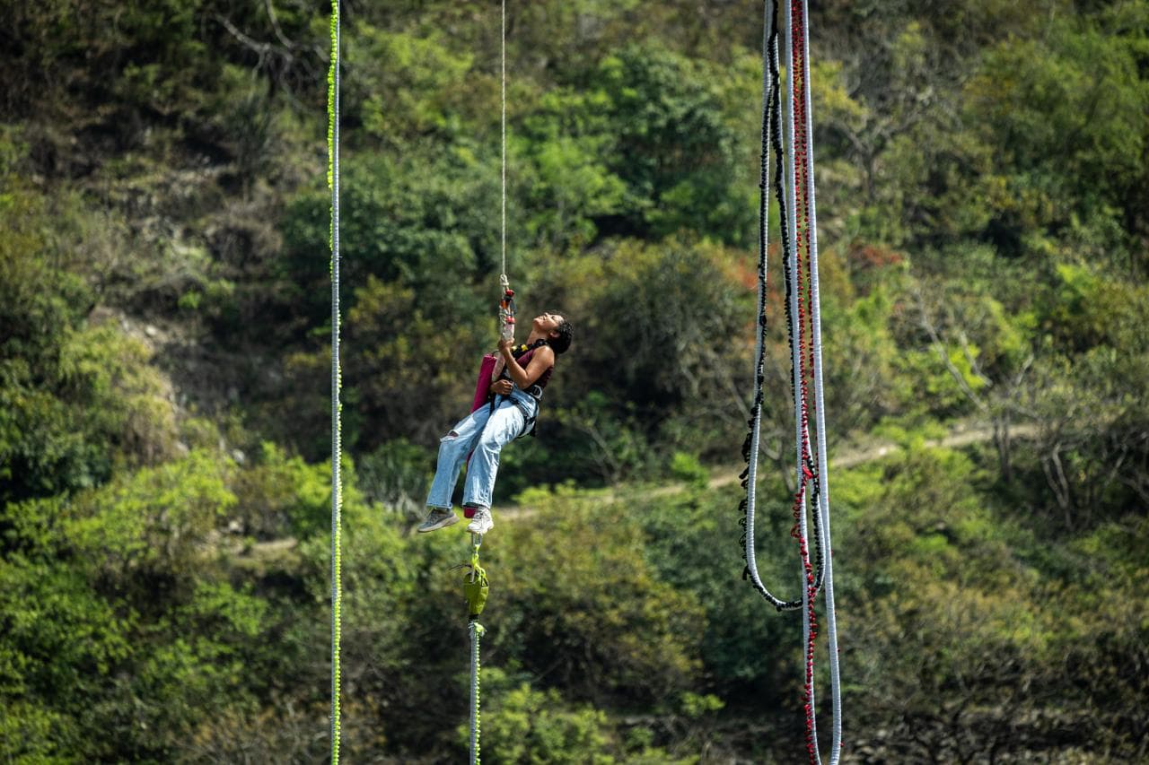 A bungee jumper falling from the 219-metre Devprayag platform above the Ganga near Rishikesh