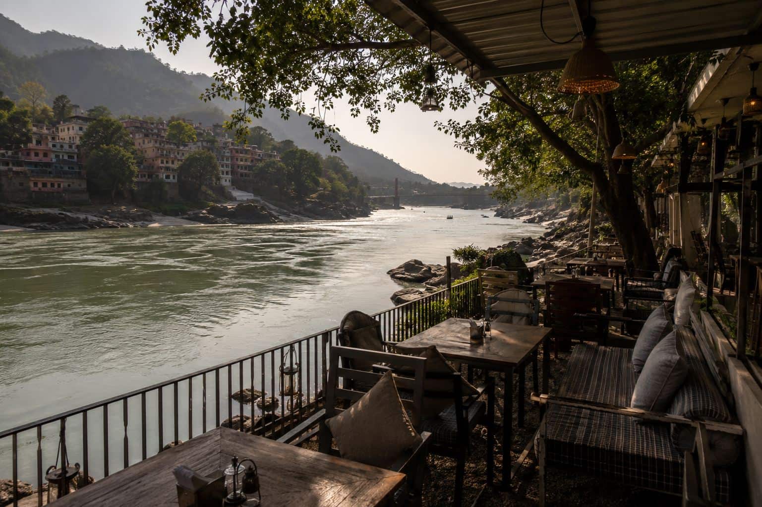 A riverside café terrace overlooking the Ganga at golden hour
