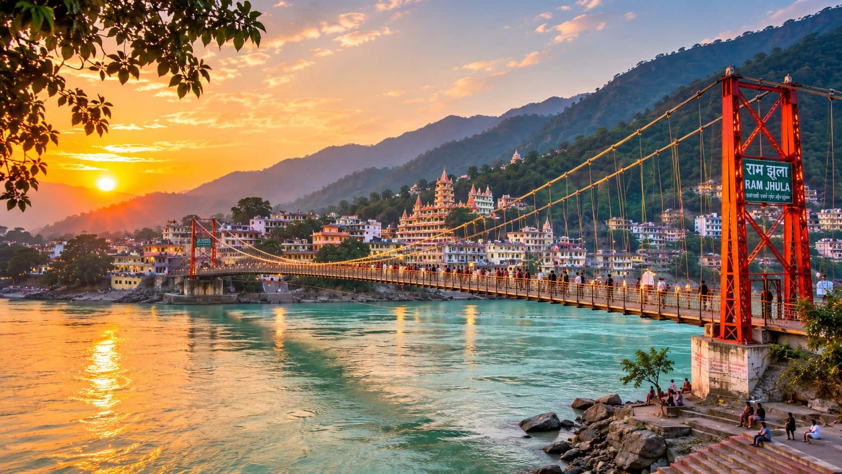 The Ganga at Ram Jhula in Rishikesh, with temples and ashram buildings stacked down the slope above the water
