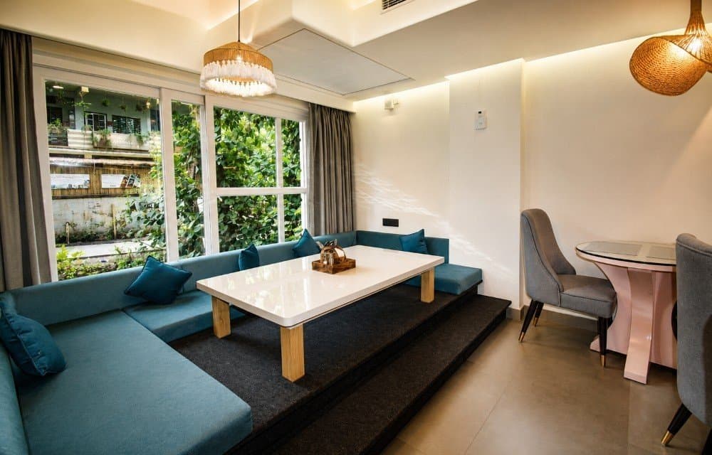 A café seating nook with a garden view at Arista Haven, Tapovan, Rishikesh