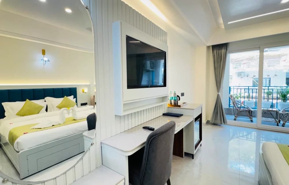 The Superior Room with Balcony at Arista Haven, Tapovan, Rishikesh, with the balcony door open