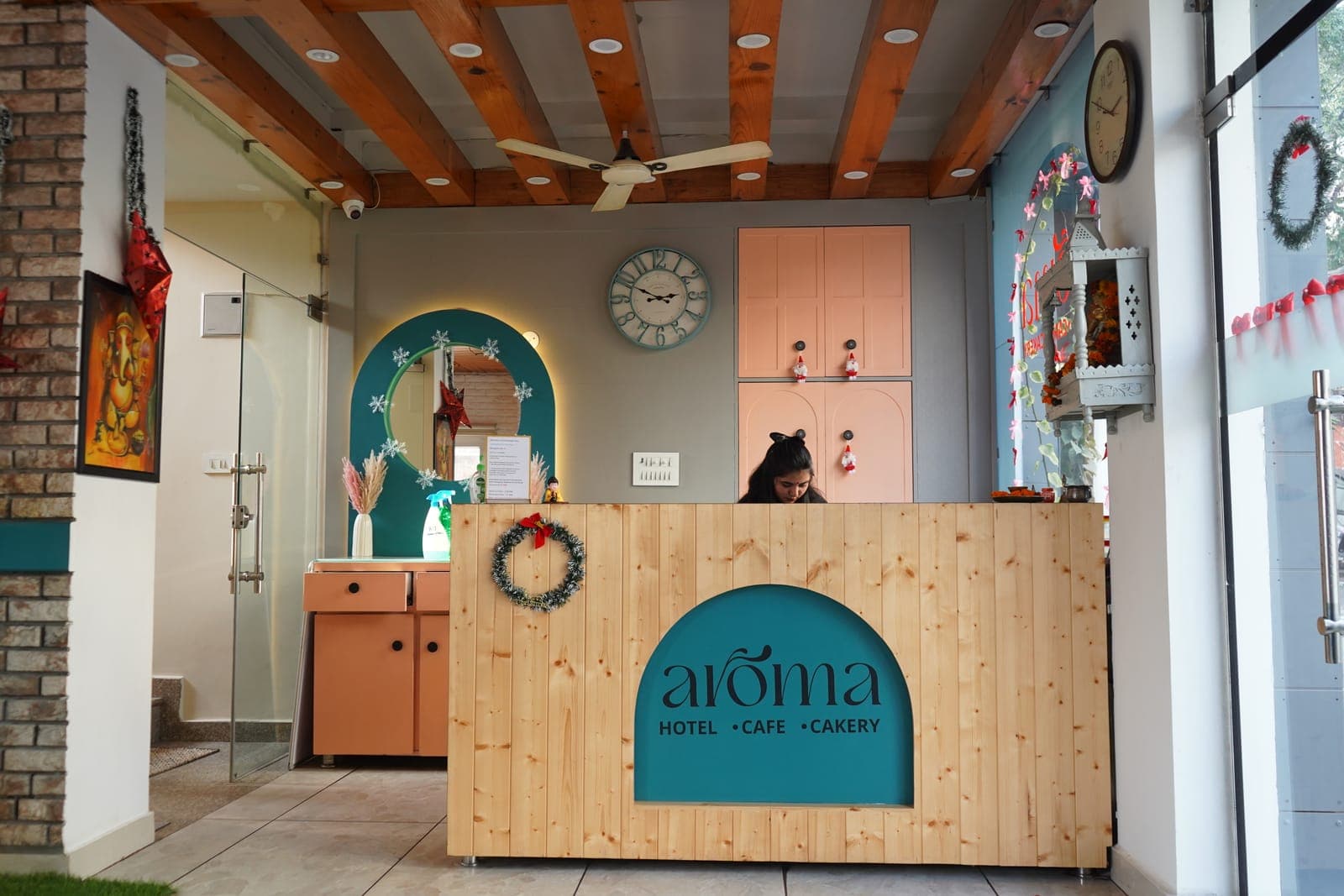 The reception desk at Aroma Hotel, Cafe & Cakery, Rishikesh