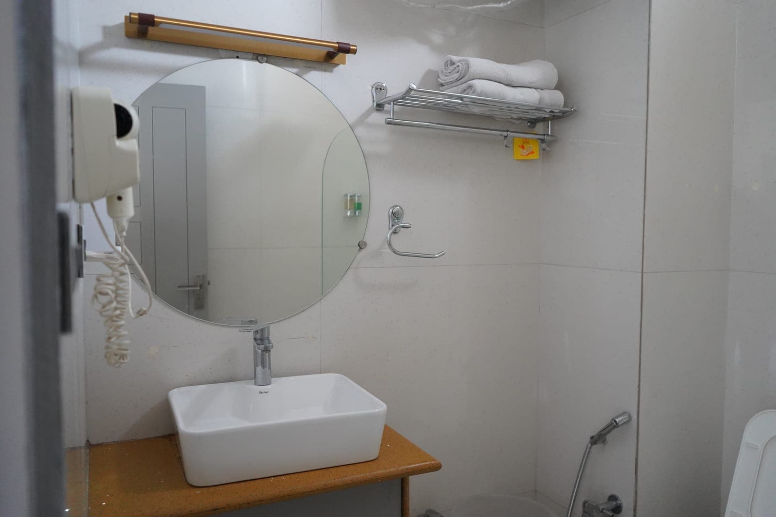 The bathroom sink in the Deluxe Room with Balcony at Aroma Cafe Hotel, Rishikesh
