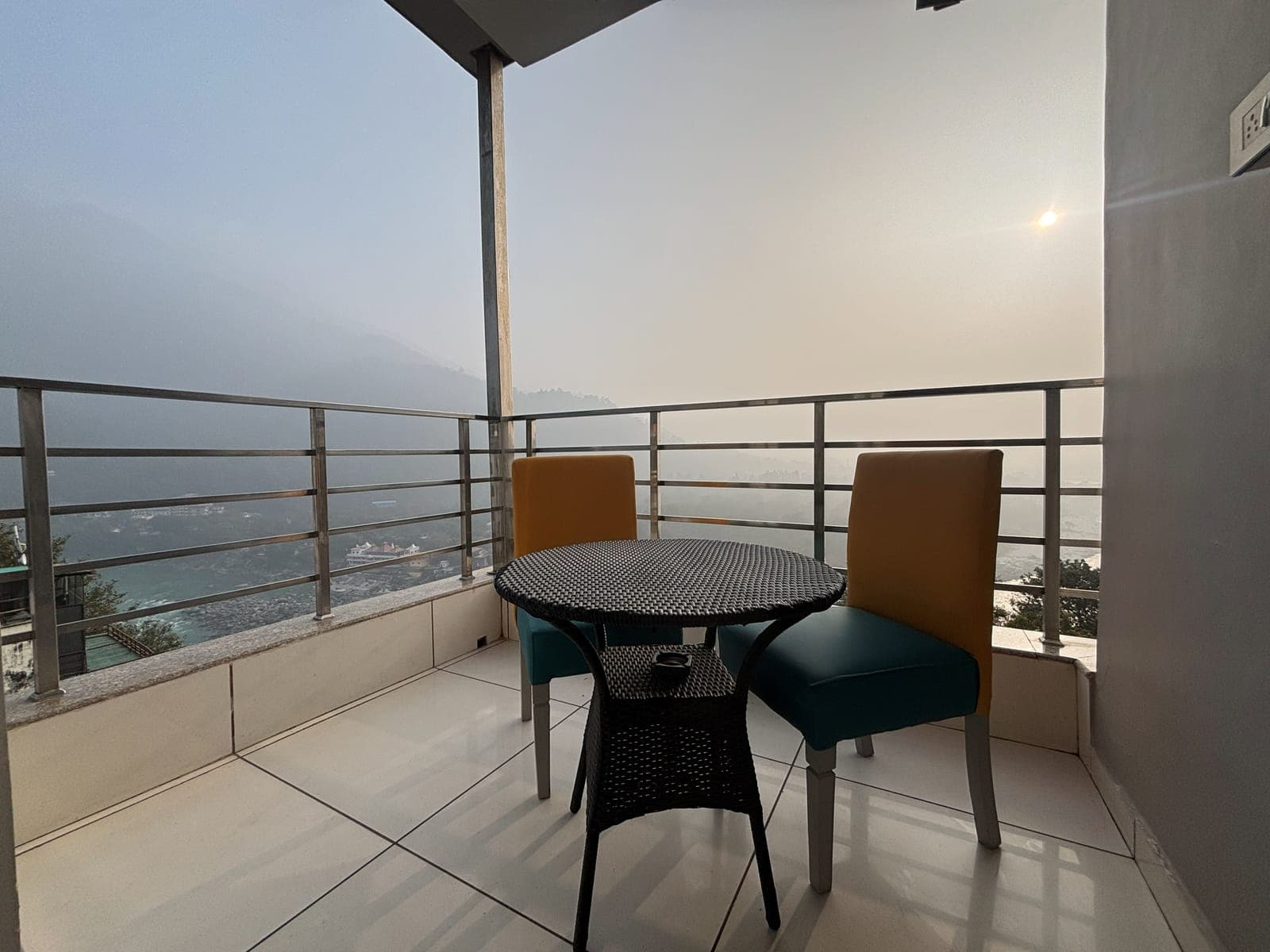 The Ganga-view balcony of the Executive Room at Aroma Cafe Hotel, Rishikesh