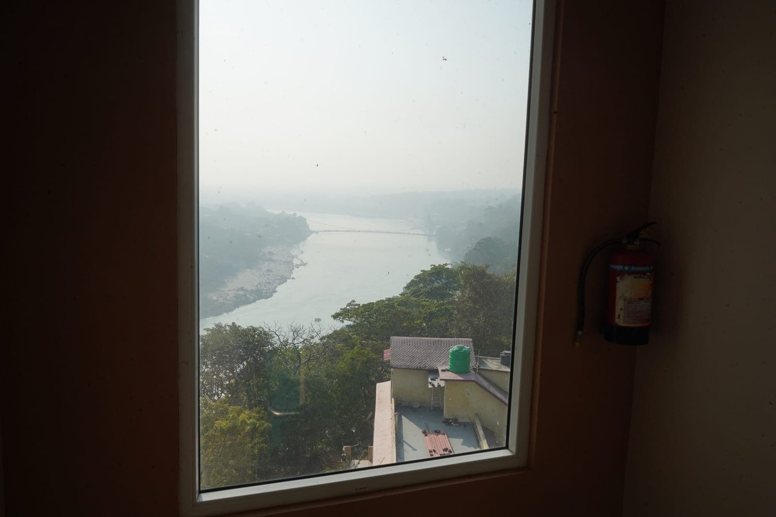 The Ganga river bend, seen through the Loft room's own window at Aroma Cafe Hotel, Rishikesh