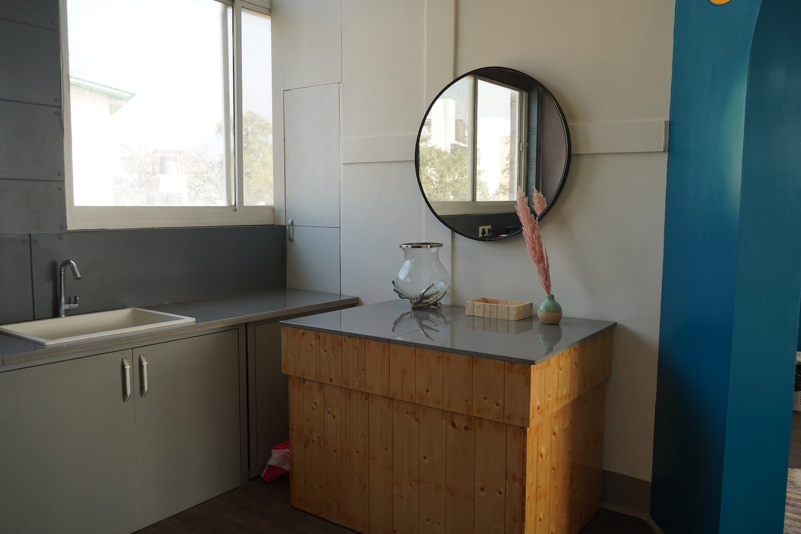 The Loft room's living area, orange accent wall, at Aroma Cafe Hotel, Rishikesh