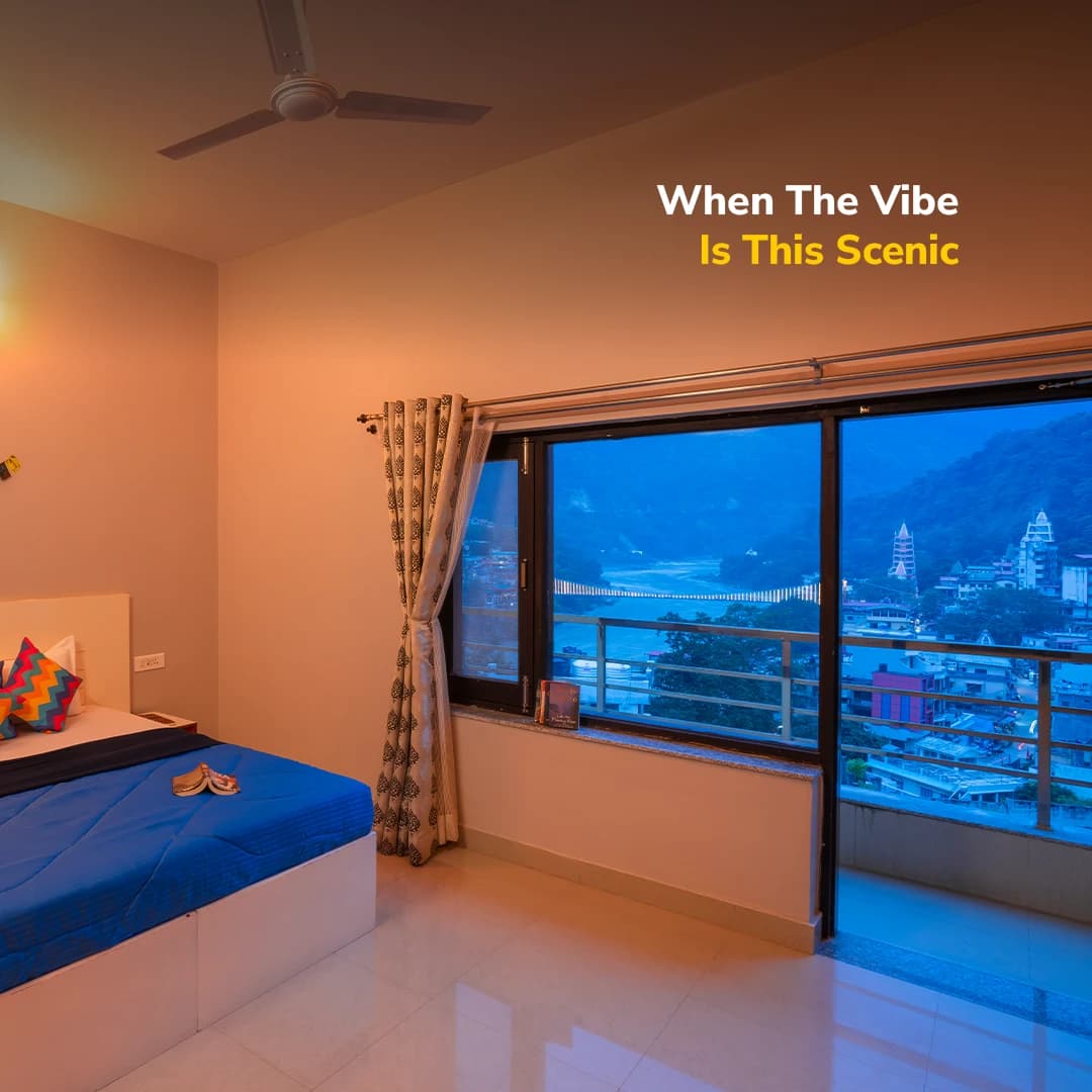 A private room's window view of the Lakshman Jhula bridge at goSTOPS Rishikesh, Lakshman Jhula