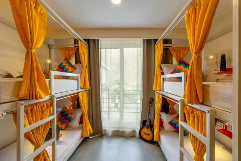 Inside the AC 6-Bed Female Dorm — Balcony, Ensuite at goSTOPS Rishikesh, Tapovan PLUS