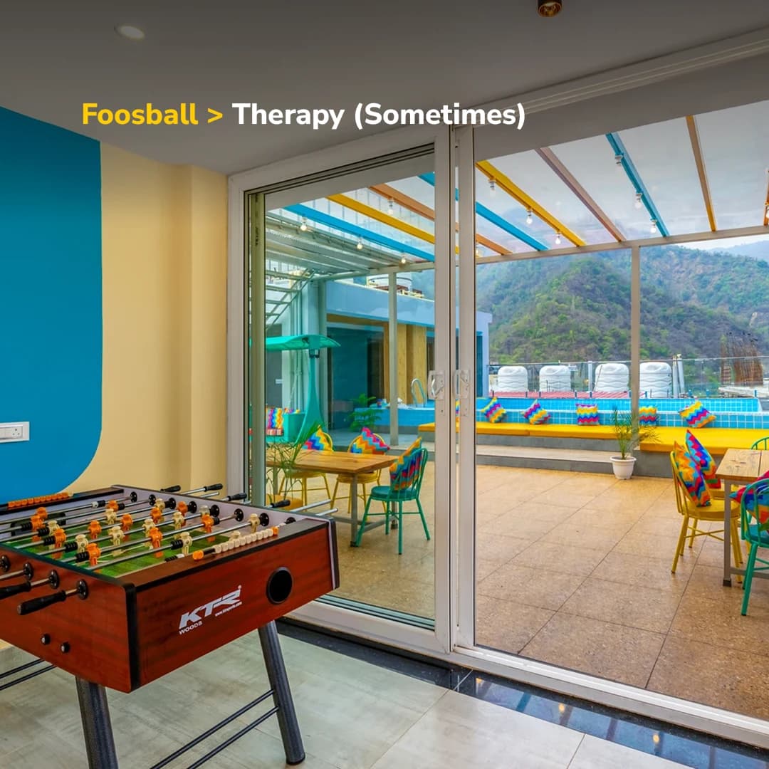 Foosball table opening onto the rooftop terrace at goSTOPS Rishikesh, Tapovan PLUS