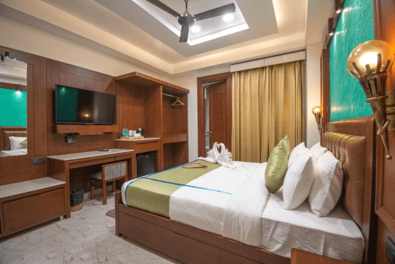Wardrobe and balcony door in the Premium Room with Balcony at Holy Shivana, Rishikesh