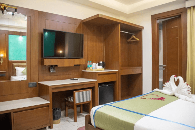 TV, kettle and wardrobe in the Premium Room with Balcony at Holy Shivana, Rishikesh