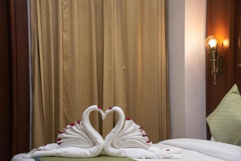 Bed detail in the Premium Room with Balcony at Holy Shivana, Rishikesh