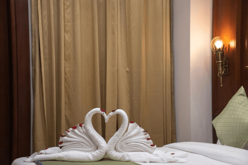 Bed detail in the Premium Room with Balcony at Holy Shivana, Rishikesh