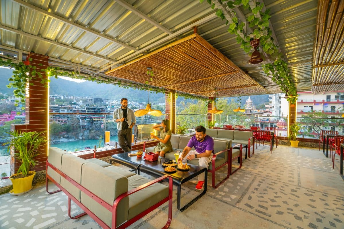Rooftop café with mountain and river views at The Hosteller Rishikesh, Ganges