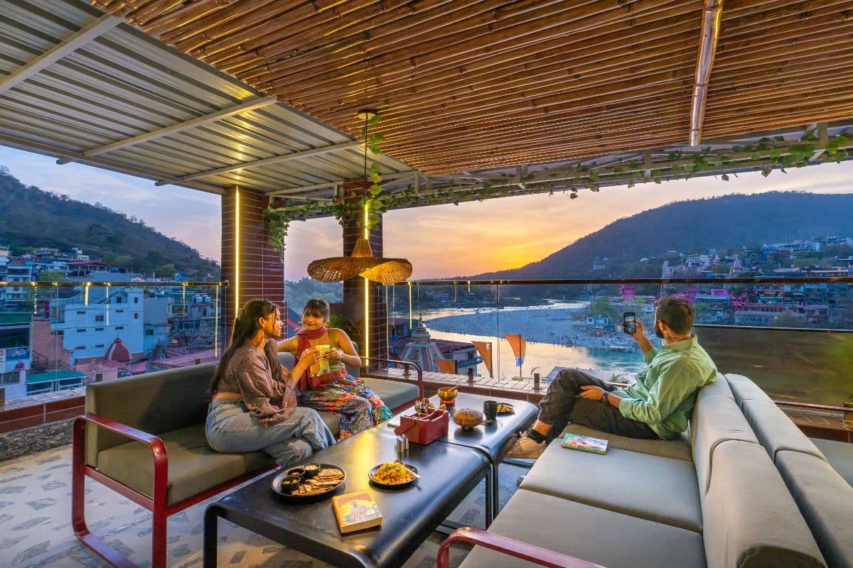 Rooftop café at sunset with river views at The Hosteller Rishikesh, Ganges