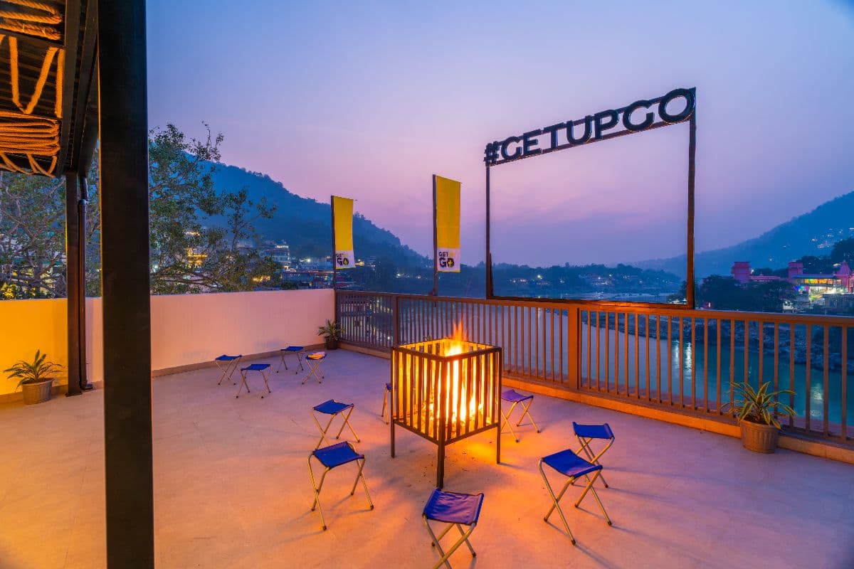 Rooftop bonfire area at dusk at The Hosteller Rishikesh, Laxman Jhula