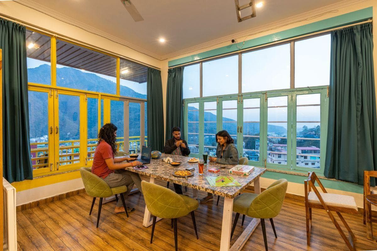 Dining table with mountain views at The Hosteller Rishikesh, Upper Tapovan