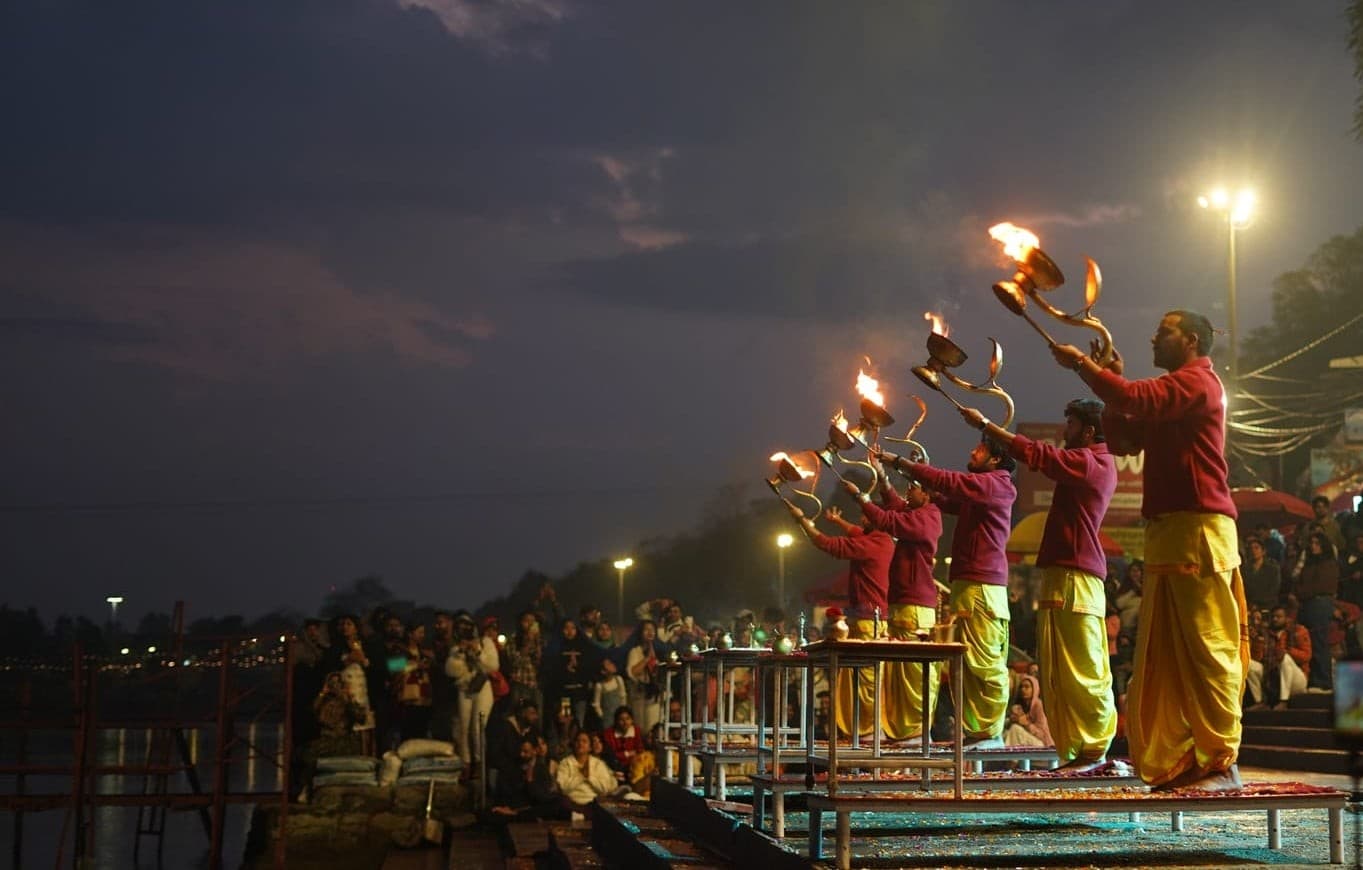Lamps and fire raised at the evening Ganga aarti on the ghat at Parmarth Niketan, Rishikesh