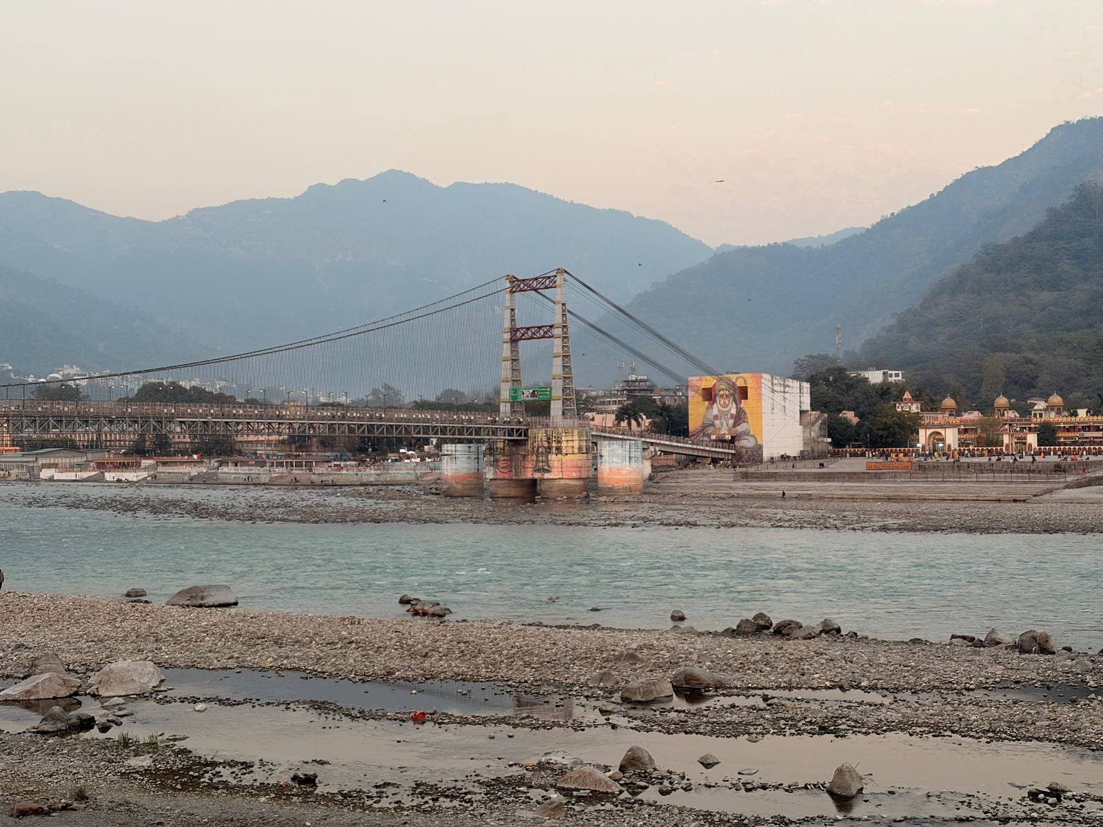 First view of Lakshman Jhula bridge across the Ganga — your first hello to Rishikesh