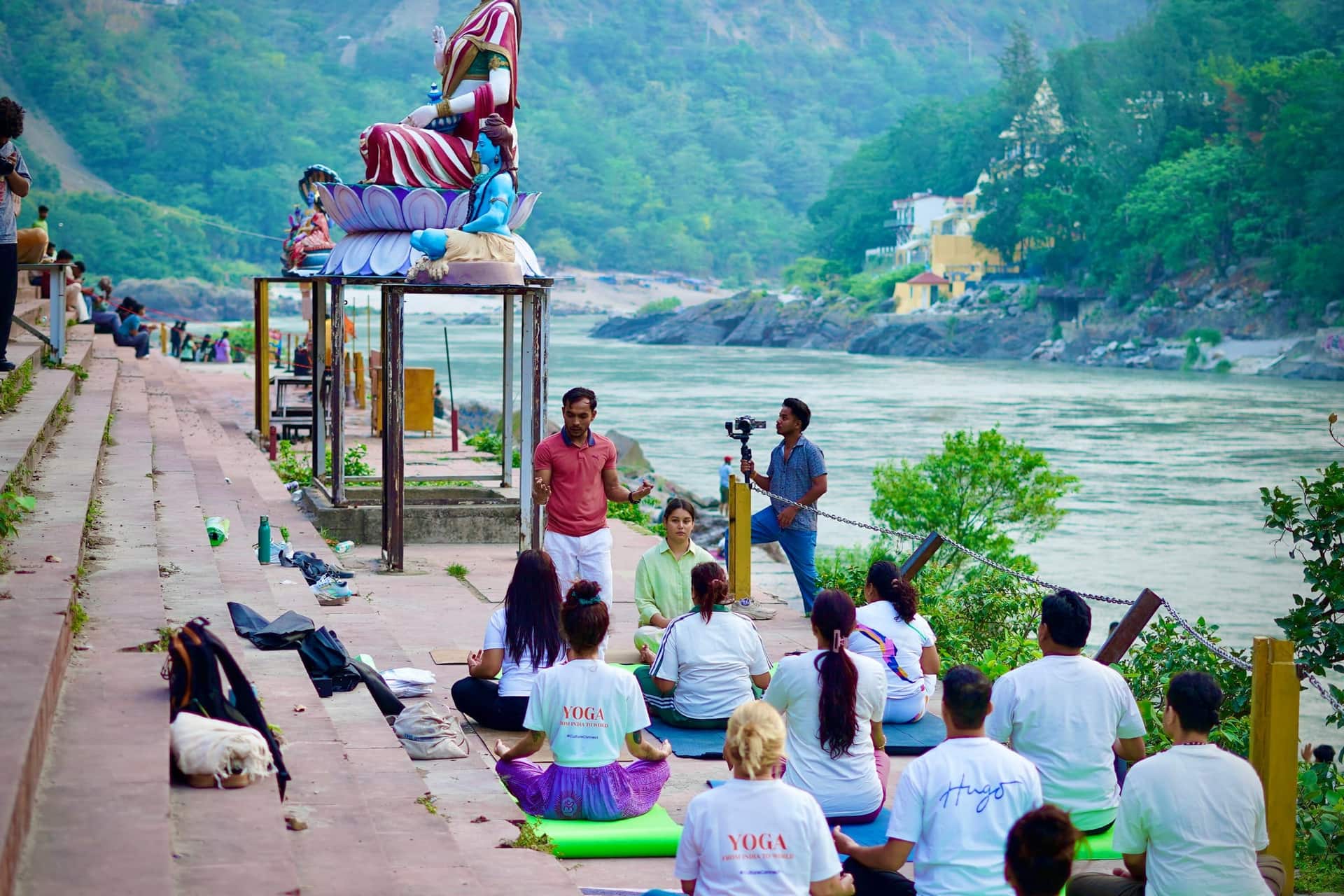 Rahul, your Book My Rishikesh host, speaking with a small group of guests by the Ganga