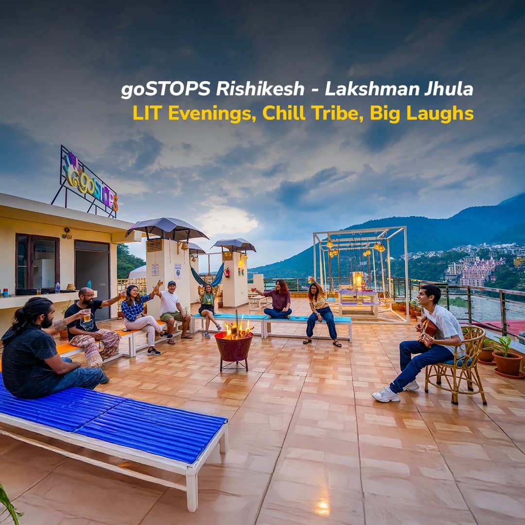 Rooftop terrace at goSTOPS Rishikesh, Lakshman Jhula, with the Ganges and Lakshman Jhula bridge behind
